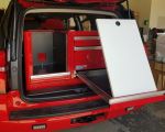 Red lightweight storage with whiteboard for SUV